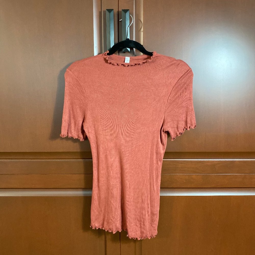 ribbed orange mock neck t-shirt with ruffle edges